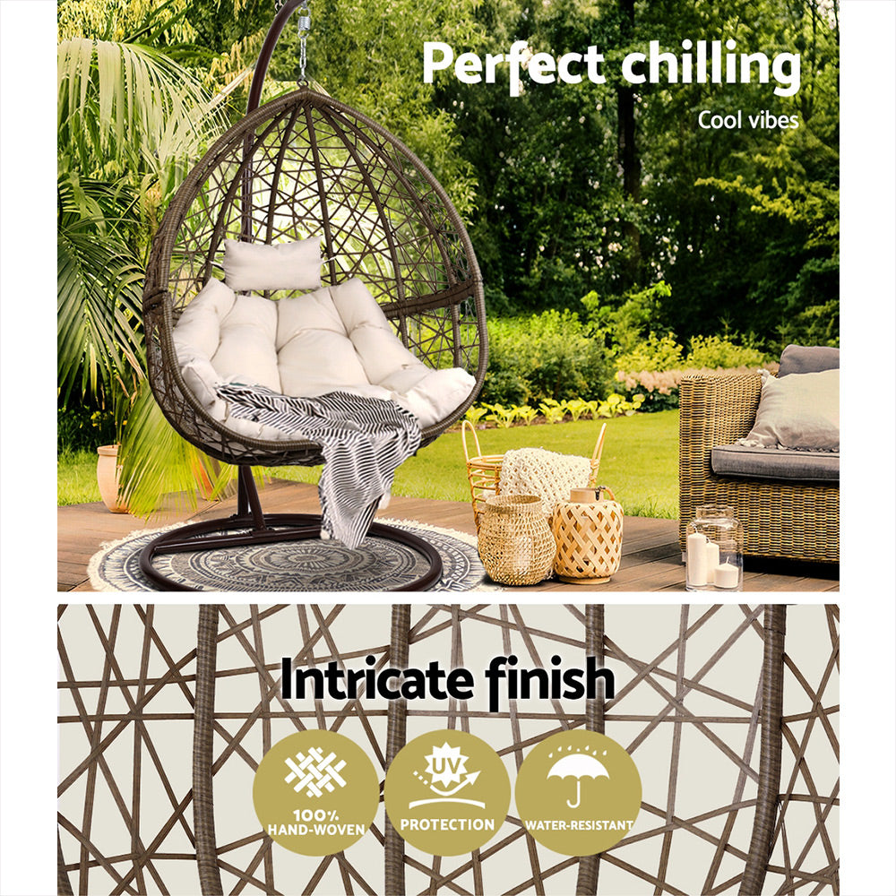 Perfect chilling self supported wicker bamboo ratan Egg seat hammock in beautiful green outdoor garden setting.