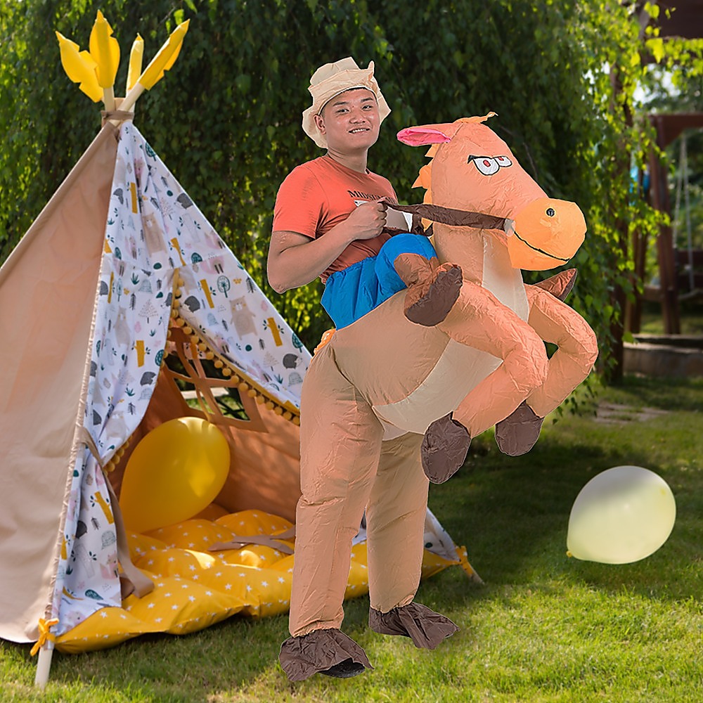 Man in an inflatable blow up cowboy and horse costume for the Melbourne cup Halloween or parties there is a colourful tee pee in the background with balloons in your backyard.