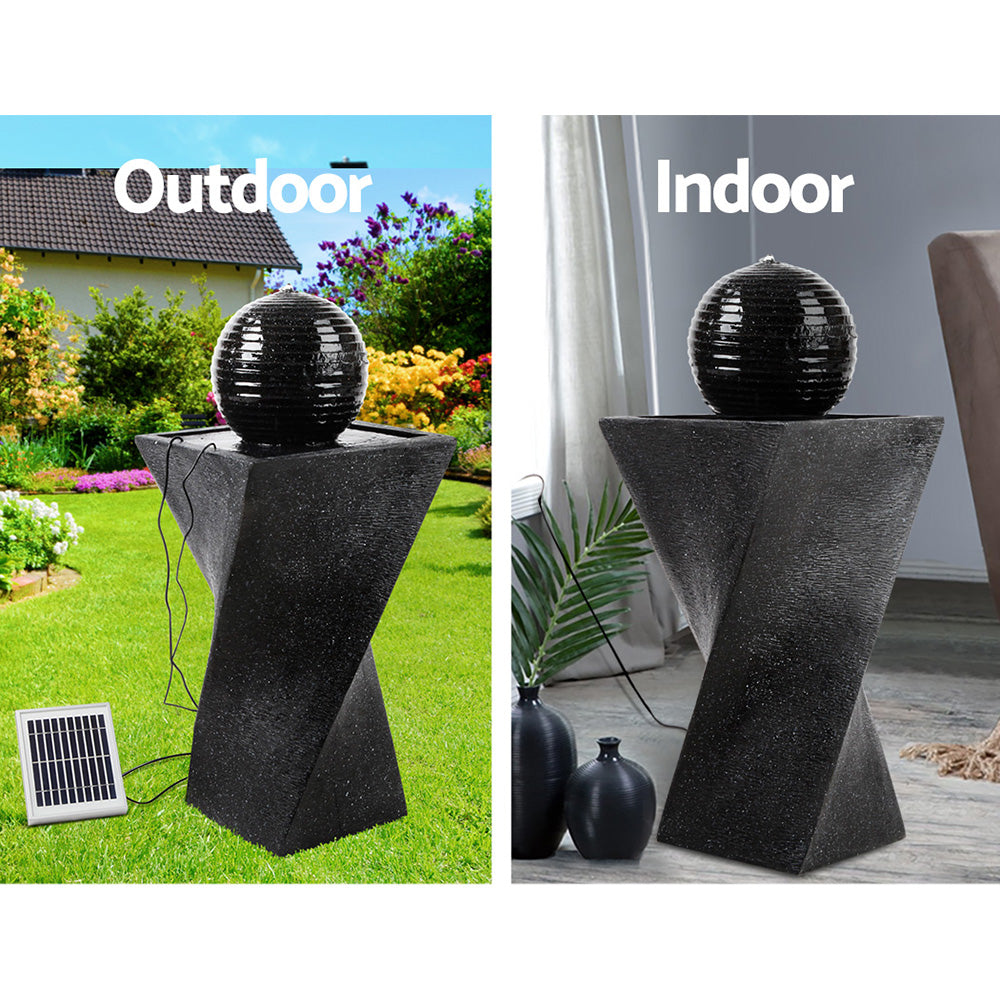 Black water fountain shaped like a twisted vertical rectangle with a ball on top with solar panel, text says outdoor indoor 